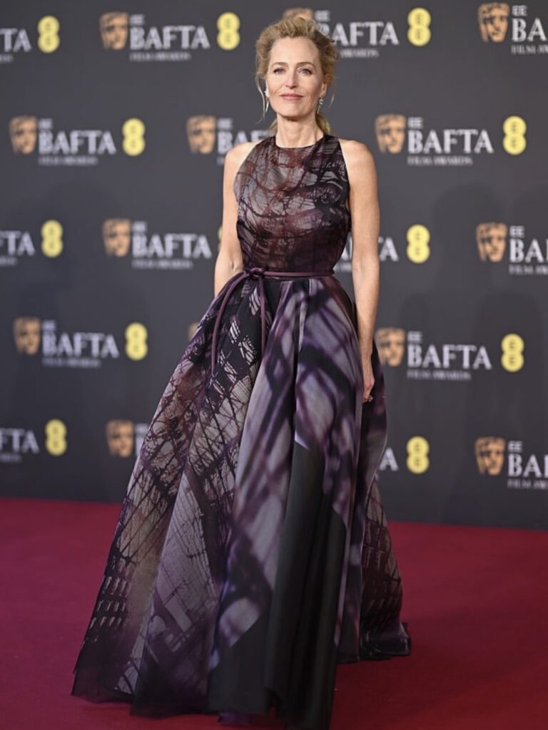 Gillian Anderson in a halter-neck printed Roksanda gown with abstract purple tones at the 79th British Academy Film Awards — late-winter celebrity outfits