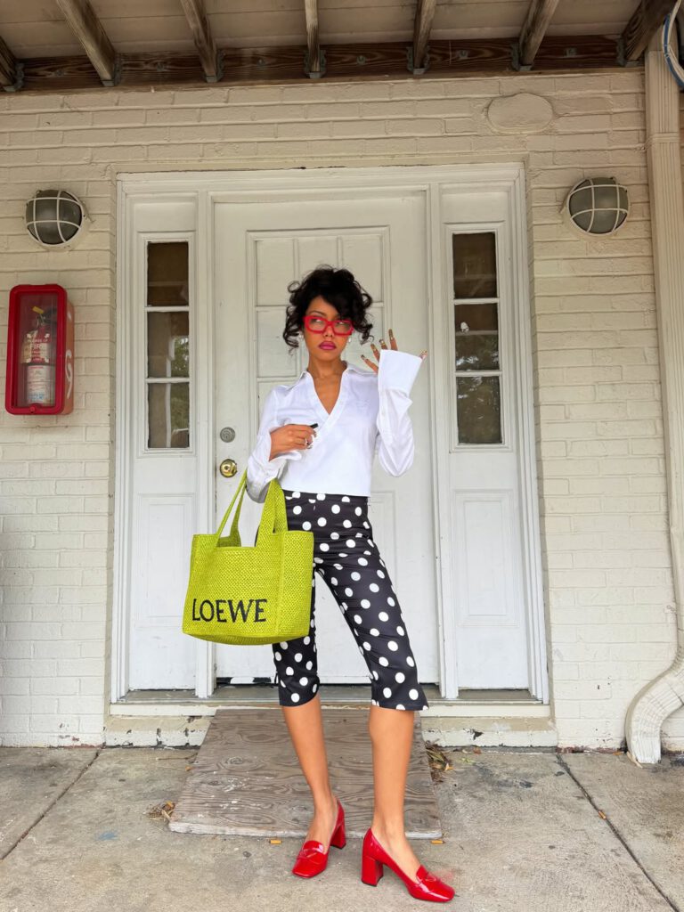 woman wearing white shirt and polka dot capri pants for summer capsule wardrobe essential